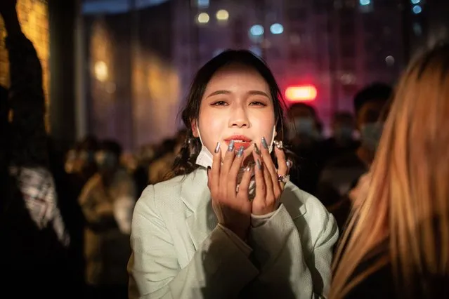 A woman attends a concert at a live house in Wuhan, China, 30 December 2020. Life in Wuhan, a Chinese city of more than 11 million, which nearly a year ago became the epicenter of the coronavirus outbreak is returning to normal. Since May the capital of Hubei province has not recorded locally-transmitted cases of Covid-19. Nearly half a million of Wuhan's residents may have been infected with coronavirus, which is almost 10 times its official number of around 50,000 Covid-19 cases in the city, according to a study by the Chinese Center for Disease Control and Prevention. (Photo by Roman Pilipey/EPA/EFE)
