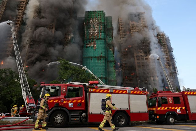 Firefighters work as efforts are underway to extinguish flames engulfing bamboo scaffolding across multiple buildings at the Wang Fuk Court housing estate in Tai Po, Hong Kong, China, on November 26, 2025. (Photo by Tyrone Siu/Reuters)