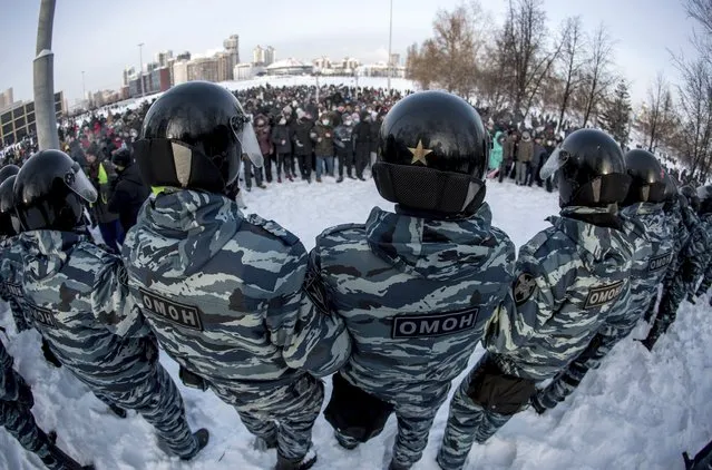 Police block a protest against the jailing of opposition leader Alexei Navalny in Yekaterinburg, Russia, Saturday, January 23, 2021. (Photo by Anton Basanayev/AP Photo)