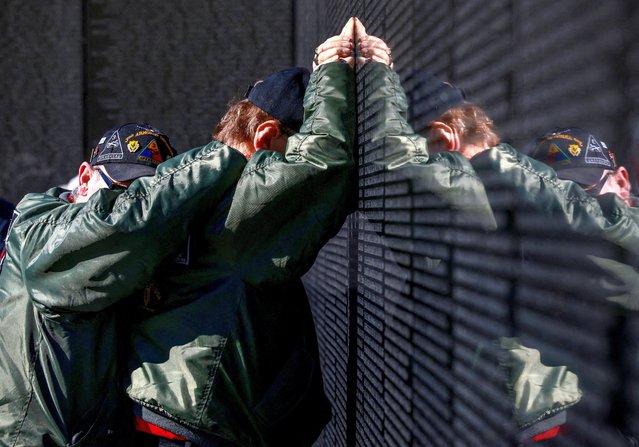 Ray Nahrgang hugs his friend and Vietnam veteran Harry Metzler as Harry touches the names of friends he lost during the Vietnam war, at the Vietnam Veterans Memorial on Veterans Day in Washington on November 11, 2025. (Photo by Evelyn Hockstein/Reuters)