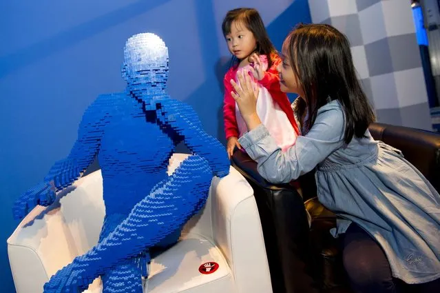 “Blue man sits in chair”. (Photo by Nathan Sawaya/The Art of the Brick)