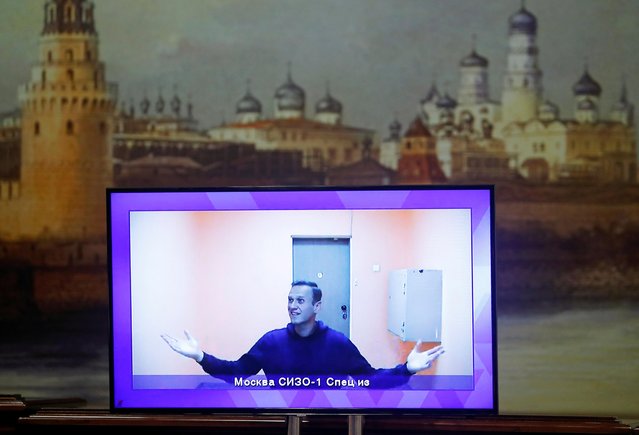 Russian opposition leader Alexei Navalny is seen on a screen via a video link during a court hearing to consider an appeal on his arrest outside Moscow, Russia on January 28, 2021. (Photo by Maxim Shemetov/Reuters)