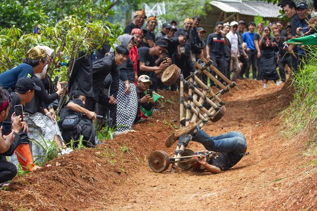 A man falls off the bamboo car in Bandung, West Java, Indonesia on November 28, 2024. This event was attended by 30 participants as part of an effort to preserve traditional games that have begun to be abandoned, especially by young people. (Photo by Algi Febri Sugita/ZUMA Press Wire/Rex Features/Shutterstock)