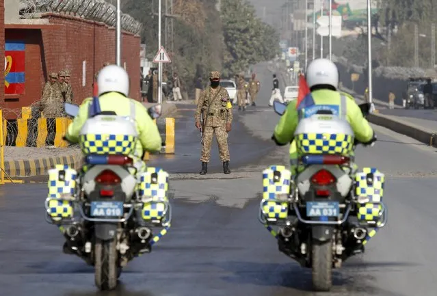 Police on motorcycle patrol a road leading to the Army Public School (APS) during a ceremony to mark the first anniversary of a Taliban attack on the school in Peshawar, Pakistan, December 16, 2015. (Photo by Fayaz Aziz/Reuters)