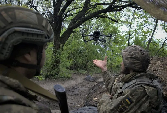 Ukrainian servicemen of a Reconnaissance team fly a drone at a front line near the town of Bakhmut, Donetsk region on May 8, 2023, amid the Russian invasion of Ukraine. (Photo by Sergey Shestak/AFP Photo)