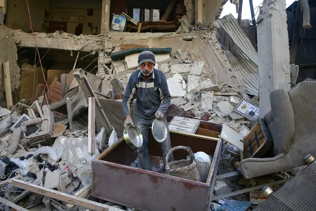 A man salvages belongings at a site hit yesterday by airstrikes in the rebel held Douma neighborhood of Damascus, Syria November 18, 2016. (Photo by Bassam Khabieh/Reuters)