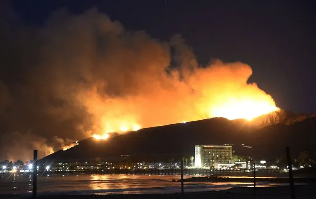 Huge flames light up the coast line the Solimar brush fire that started early Saturday morning in Ventura County, California December 26, 2015. (Photo by Gene Blevins/Reuters)