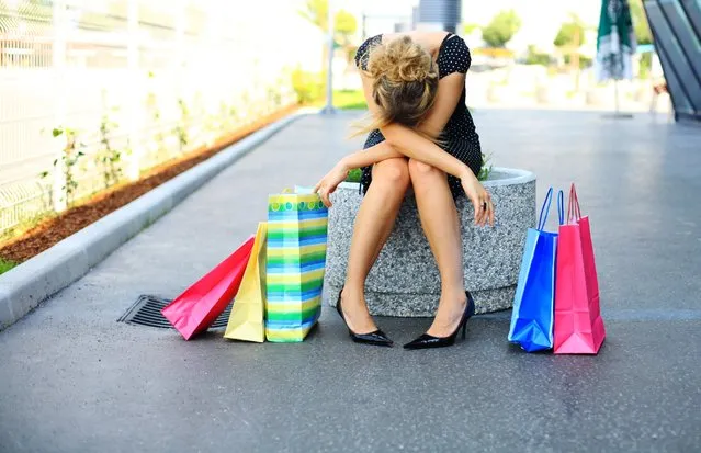 Shopping. Young woman with shopping bags. (Photo by Gremlin/Getty Images)