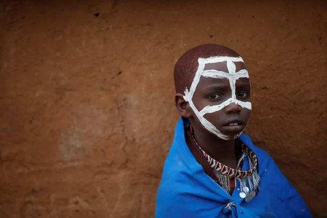 A Maasai boy with a painted face looks at the camera during an initiation into an age group ceremony near the town of Bisil, Kajiado county, Kenya on August 23, 2018. (Photo by Baz Ratner/Reuters)