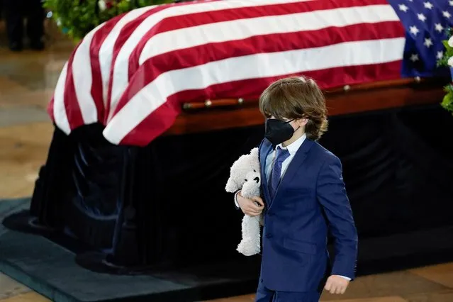 Logan Evans, son of slain U.S. Capitol Police officer William “Billy” Evans, walks past the casket during a ceremony at the Capitol in Washington, April 13, 2021. (Photo by J. Scott Applewhite/Pool via Reuters)