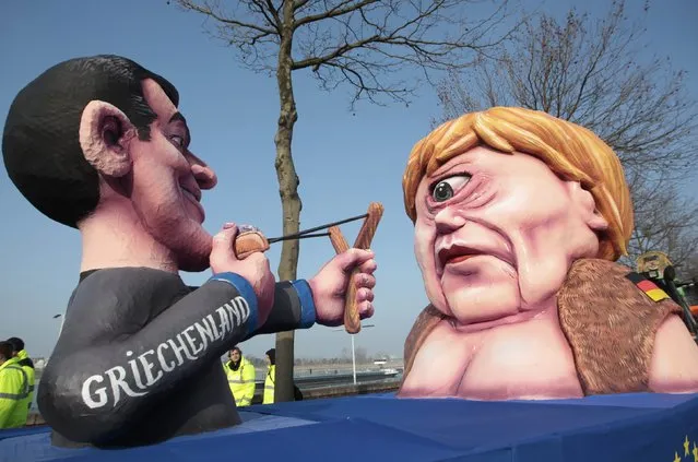 A carnival float with papier-mache caricatures of German Chancellor Angela Merkel (R) and a figure representing Greece (L) takes part in the traditional Rose Monday carnival parade in the western German city of Duesseldorf February 16, 2015. The Rose Monday parades in Cologne, Mainz and Duesseldorf are the highlight of the German street carnival season. (Photo by Ina Fassbender/Reuters)