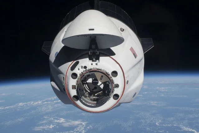 This handout image released on April 27, 2021 courtesy of NASA, shows the SpaceX Crew Dragon Endeavour as it approached the International Space Station less than one day after launching from Kennedy Space Center in Florida on April 24, 2021. The SpaceX Crew-2 astronauts, Commander Shane Kimbrough and pilot Megan McArthur with astronauts Akihiko Hoshide of the Japan Aerospace Exploration Agency and Thomas Pesquet of the European Space Agency, joined the Expedition 65 crew shortly after docking to the Harmony module's forward-facing international docking adapter. (Photo by Handout/NASA/AFP Photo)