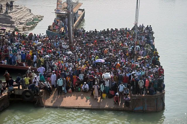 People wait to board a ferry to their hometowns ahead of the Eid al-Fitr festivities amid Covid-19 coronavirus pandemic in Munshiganj on May 9, 2021. (Photo by Munir Uz Zaman/AFP Photo)