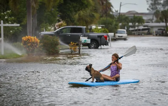 Lily Gumos, 11, of St. Pete Beach, kayaks with her French bulldog along Blind Pass Road and 86th Avenue Wednesday, August 30, 2023 in St. Pete Beach, Fla.  Hurricane Idalia made landfall Wednesday in Florida as a Category 3 storm and unleashed devastation along a wide stretch of the Gulf Coast, submerging homes and vehicles, turning streets into rivers, unmooring small boats and downing power lines in an area that has never before received such a pummeling. (Photo by Chris Urso/Tampa Bay Times via AP Photo)