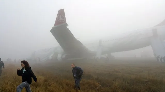 Passengers exit from a Turkish Airlines plane soon after it overshot from the runway in Kathmandu March 4, 2015. According to local media, all passengers and crew members of the flight were rescued. REUTERS/Dikesh Malhotra