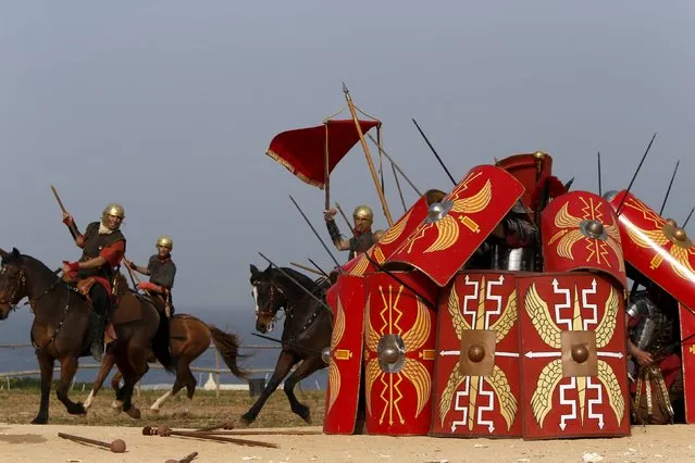 Members of the Legio X Fretensis (Malta) re-enactment group demonstrate a defensive formation while under cavalry attack during a display of ancient Roman army life at Fort Rinella in Kalkara, outside Valletta, March 22, 2015. (Photo by Darrin Zammit Lupi/Reuters)