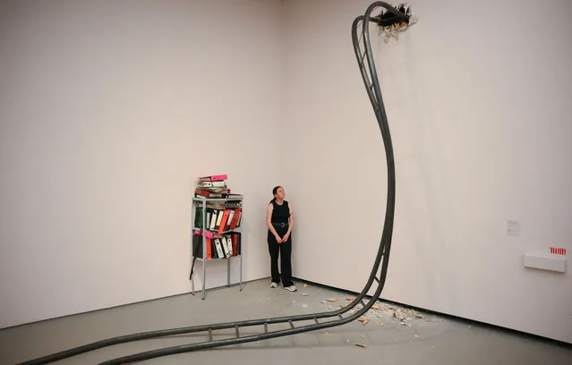 A gallery assistant poses next to installations by artist Jesse Darling entitled “Big Dipper” (2023) and “Epistemologies” (2018-2023) during a photocall for the Turner Prize 2023 at the Towner Eastbourne gallery in Eastbourne, southern England, on September 27, 2023. (Photo by Daniel Leal/AFP Photo)