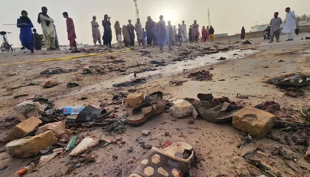 Local residents gather at the scene of a suicide bomb blast in Mastung, Balochistan, Pakistan, 29 September 2023. At least 52 people were killed and over 50 wounded on 29 September in a suicide bombing in Mastung, during a rally celebrating Eid-e-Miladun Nabi, a festival to celebrate the birth of Prophet Muhammad, according to the officer-in-charge of the police station at Mastung, Mohammad Javed Lehri. Pakistan has witnessed a surge in terrorism-related incidents, including sectarian violence between Islamists, following the fall of Kabul to the Afghan Taliban. (Photo by Jamal Taraqai/EPA/EFE)