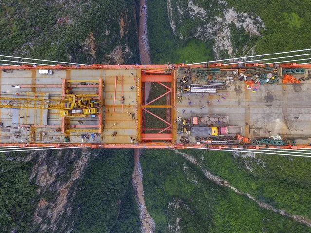 Aerial view of the Beipan River expressway bridge (or Beipanjiang bridge) under construction on September 10, 2016 in Bijie, Guizhou Province of China. The 1,341.4-meter-long Beipan River expressway bridge has a height equivalent to a 200-story building, which makes it the world's highest bridge down to the ground or water surface. The bridge spanning the Beipanjiang Valley was started to build in 2013 and completed the main connection on September 10, 2016. (Photo by VCG/Getty Images)