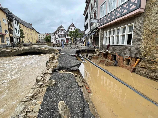 A road is distroyed in Bad Muenstereifel, Germany, Thursday, July 15, 2021 after heavy rainfall and the flooding of the Erft river. People have died and dozens of people are missing in Germany after heavy flooding turned streams and streets into raging torrents, sweeping away cars and causing some buildings to collapse. (Photo by B&S/dpa via AP Photo)