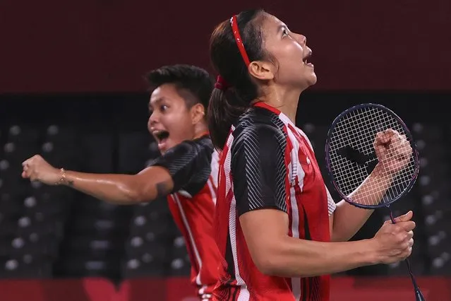 Greysia Polii (R) and Apriyani Rahayu of Team Indonesia celebrate after their victory against Lee Sohee and Shin Seungchan of Team South Korea during a Women’s Doubles Semi-final match on day eight of the Tokyo 2020 Olympic Games at Musashino Forest Sport Plaza on July 31, 2021 in Chofu, Tokyo, Japan. (Photo by Leonhard Foeger/Reuters)