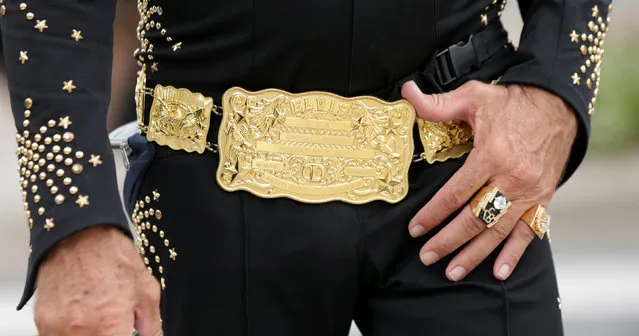 Al 'Alvis' Gersbach, the official ambassador of the 25th annual Parkes Elvis Festival, walks through town with his Elvis belt buckle, in the rural Australian town of Parkes, west of Sydney, Australia January 13, 2017. (Photo by Jason Reed/Reuters)