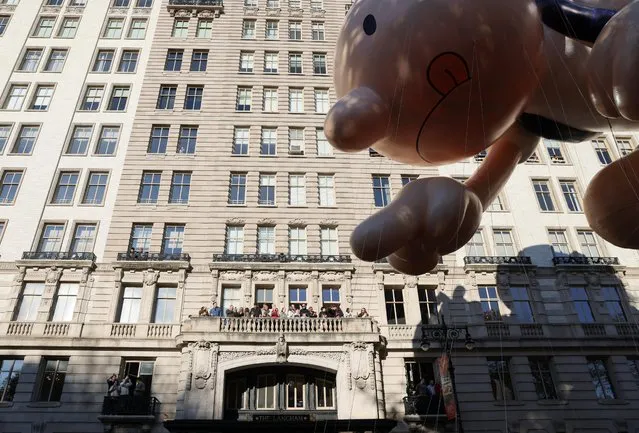 People watch as the Diary of a Wimpy Kid ballon flies during the 96th Macy's Thanksgiving Day Parade in Manhattan, New York City, U.S., November 24, 2022. (Photo by Andrew Kelly/Reuters)