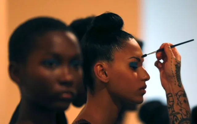 Models get ready backstage during Africa African Summer 2016 Ready To Wear collection during Sao Paulo Fashion Week in Sao Paulo April 17, 2015. (Photo by Paulo Whitaker/Reuters)