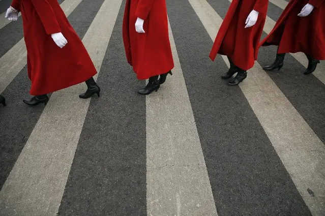Hostesses cross the street outside the Great Hall of the People during meetings ahead of Saturday's opening ceremony of the National People's Congress (NPC), in Beijing, China March 4, 2016. (Photo by Damir Sagolj/Reuters)