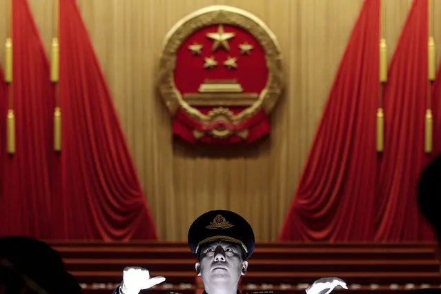 A Chinese military conductor instructs his music band members during a rehearsal for the opening session of the China's National People's Congress at the Great Hall of the People in Beijing, Tuesday, March 5, 2019. (Photo by Andy Wong/AP Photo)
