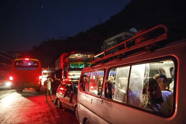 People ride on a van as traffic is affected by a landslide caused by an earthquake, in Kurintar, Nepal April 27, 2015. (Photo by Athit Perawongmetha/Reuters)