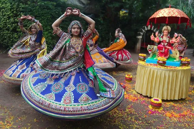 Indian women in traditional attire practice Garba, a traditional dance of Gujarat state, ahead of Hindu festival of Navratri in Ahmadabad, India, Friday, October 1, 2021. The Hindu festival of Navratri or nine nights will begin from Oct. 7. (Photo by Ajit Solanki/AP Photo)