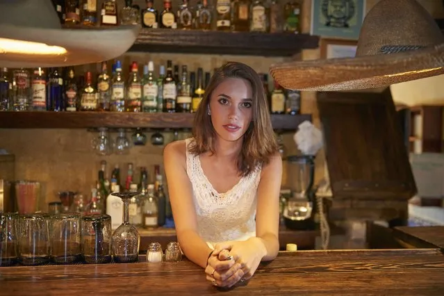 Bartender leaning on bar in restaurant. (Photo by Larry Williams & Associates/Getty Images)