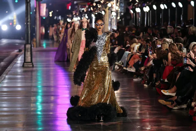Models walk on the sidewalk of Hollywood Blvd during the Gucci Love Parade fashion show in Los Angeles, California, U.S., November 2, 2021. (Photo by John Salangsang/Rex Features/Shutterstock)