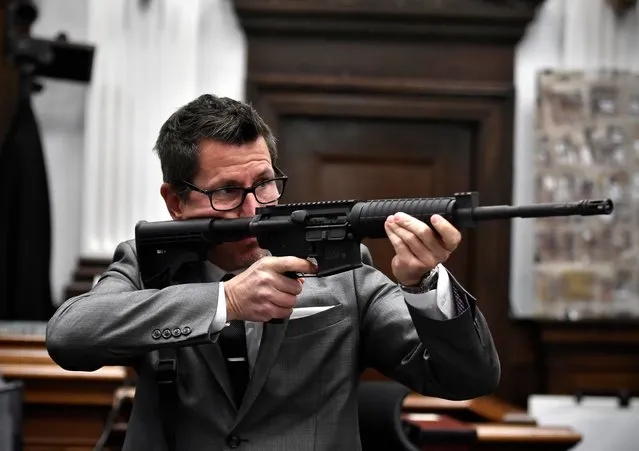 Assistant District Attorney Thomas Binger holds Kyle Rittenhouse's gun as he gives the state's closing argument in Kyle Rittenhouse's trial at the Kenosha County Courthouse in Kenosha, Wis., on Monday, November 15, 2021. Rittenhouse is accused of killing two people and wounding a third during a protest over police brutality in Kenosha, last year. (Photo by Sean Krajacic/The Kenosha News via AP Photo/Pool)