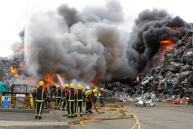 Members of the West Midlands fire service tackle a blaze in Birmingham, UK involving up to 800 tonnes of mixed plastic, rubber and metal on March 30, 2016. At its peak more than 100 firefighters were drafted in to extinguish the fire, which is believed to have started accidentally. (Photo by West Midlands Fire Service/PA Wire)