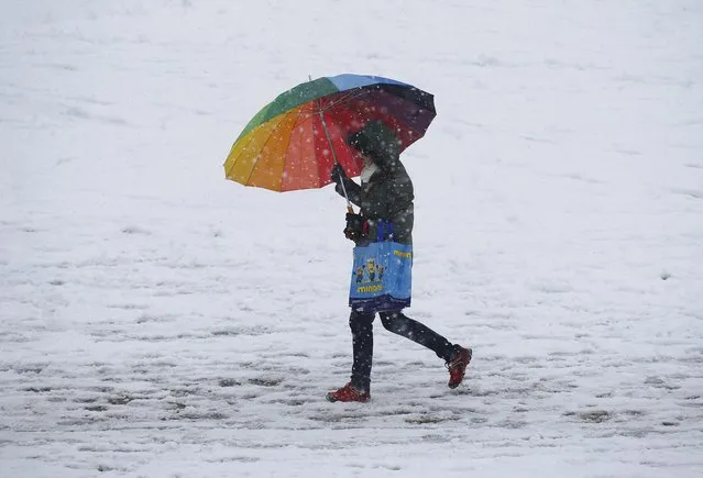A woman walks through snow in Buxton, Britain March 4, 2016. (Photo by Darren Staples/Reuters)