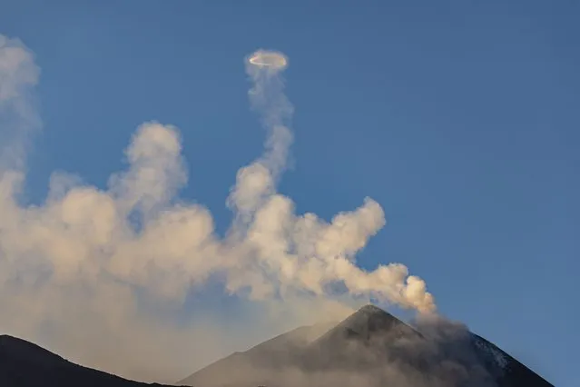 A view of “Volcanic Vortex Rings” which rise hundreds of meters above the rim that is blown out from the Etna volcano that is active again in Catania, Italy on April 07, 2024. Etna volcano is back in activity and for the past few days it has been putting on a show with a very special phenomenon, considered rare, huge rings of glowing gas called Volcanic Vortex Rings. (Photo by Salvatore Allegra/Anadolu via Getty Images)