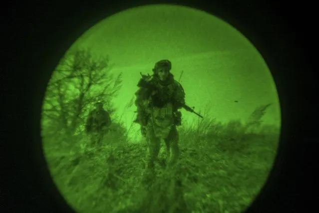Ukrainian servicemen of the 3rd Assault brigade are seen through night vision goggles, or NVG, during a night mission on the frontline near Avdiivka, Donetsk region, Ukraine, Wednesday, March 20, 2024. Servicemen of the 3rd Assault brigade continue to hold defense lines in Donetsk region after Ukrainian army left Avdiivka in February, 2024. (Photo by Alex Babenko/AP Photo)