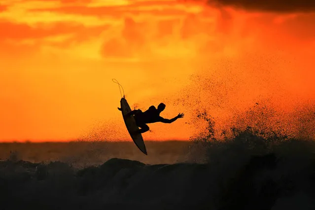 A surfer warms up at sunrise ahead of the 2024 Rip Curl Pro Bells Beach on March 27, 2024 in Winkipop, Australia.  (Photo by Morgan Hancock/Getty Images)