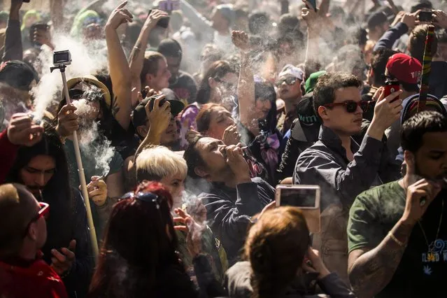 People gather to smoke marijuana during the “420 Toronto” rally in Toronto on Wednesday, April 20, 2016. Cannabis possession is illegal in most countries under a 1925 treaty called the International Opium Convention. But just like the U.S., some nations either flout the treaty or don't enforce it. Legalization supporters consider pot possession either legal or tolerated in Argentina, Bangladesh, Cambodia, Canada, Chile, Colombia, the Czech Republic, India, Jamaica, Jordan, Mexico, Portugal, Spain, Uruguay, Germany and the Netherlands. (Photo by Mark Blinch/The Canadian Press via AP Photo)