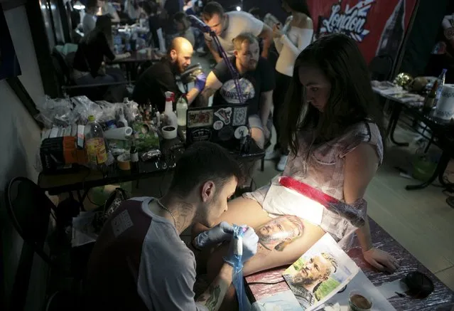 Tattoo artists work on clients during the second International Tattoo Festival in Sochi, Russia, April 23, 2016. (Photo by Kazbek Basayev/Reuters)