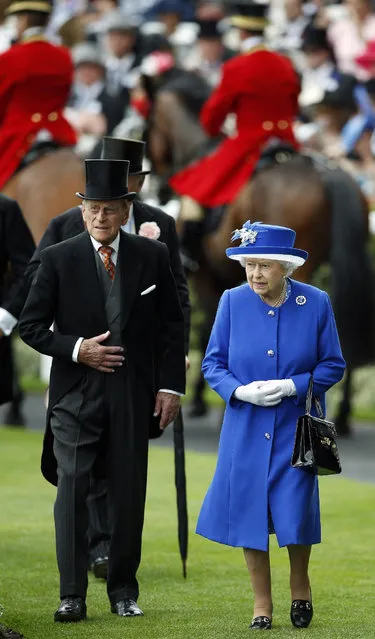 Britain's Queen Elizabeth II and Prince Philip, the Duke of Edinburgh, walk in the paddock on the second day of Royal Ascot horse racing meet at Ascot, England, Wednesday, June 17, 2015. Royal Ascot is the annual five day horse race meeting that Britain's Queen Elizabeth II attends every day of the event. (AP Photo/Alastair Grant)