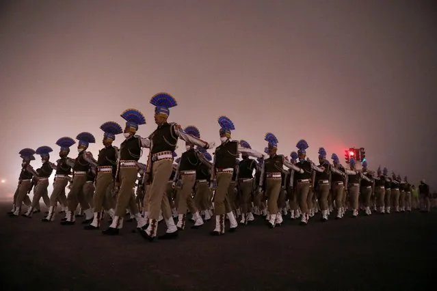 Indian Army soldiers take part in the rehearsal for the Republic Day parade on a foggy winter morning, in New Delhi, India, January 14, 2022. (Photo by Anushree Fadnavis/Reuters)