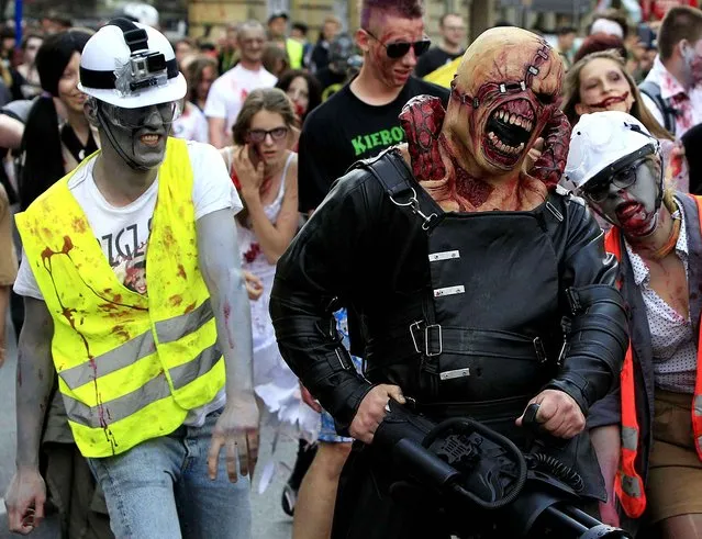 Young people dressed as zombies gather to take part in a Zombie Walk on streets of Warsaw, Poland, Saturday, June 27, 2015. (Photo by Czarek Sokolowski/AP Photo)