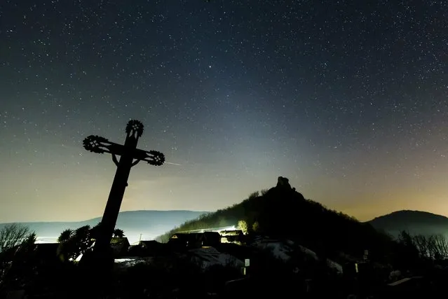 In a picture issued on February 8, 2019 the white glow of zodiacal light is visible in the night sky as photographed near Hajnacka, southern Slovakia on Thursday, Feb. 7, 2019. The faint light is caused by interplanetary dust reflecting sunlight. The astronomical phenomenon in the temperate zones is most clearly visible in February and March after sunset and in September and October before sunrise, when the zodiac is positioned at a steep angle to the horizon. (Photo by Peter Komka/MTI via AP Photo)