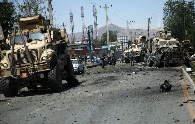 Afghanistan security personnel work at the site of a suicide attack in Kabul, Afghanistan, Tuesday, June 30, 2015. (Photo by Massoud Hossaini/AP Photo)