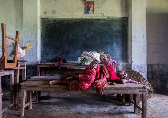 A woman displaced by the recent flood sleeps inside a classroom of Shree Sarsawati Higher Secondary School at Bhalohiya village in Rautahat, Nepal, July 17, 2019. (Photo by Riwaj Rai/Reuters)