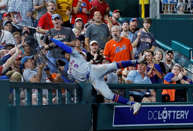New York Mets outfielder Brandon Nimmo leaps into the netting to catch a foul ball hit at Nationals Park in Washington DC. on June 4, 2024. (Photo by Geoff Burke/USA TODAY Sports)