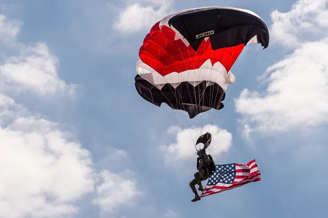 A member of the NATO parachute demonstration team lands during a change of command ceremony at NATO military headquarters in Mons, southern Belgium on Wednesday May 4, 2016. U.S. Army General Curtis  M. Scaparrotti was installed as NATO's 18th supreme allied commander Europe (SACEUR). The commander, by tradition an American general or admiral, is responsible for the overall direction and conduct of NATO's global military operations. (Photo by Geert Vanden Wijngaert/AP Photo)